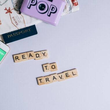 Travel essentials including passport, map, and health passport app ready for post-pandemic journeys.